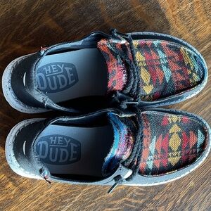 Hey Dude women’s Aztec Slip-On Shoes in Black, Red, Yellow, Blue